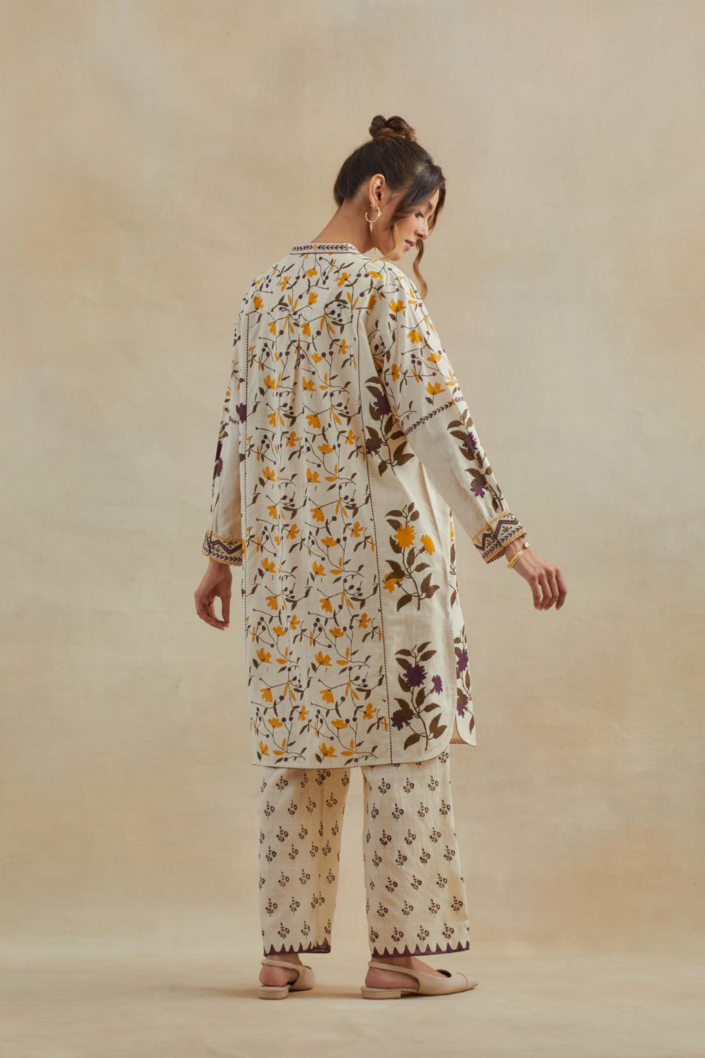 Beige short kurta crafted from soft cotton, featuring an all-over hand block print of yellow and purple flowers, paired with Beige cotton straight pants with all-over small booti hand block print.