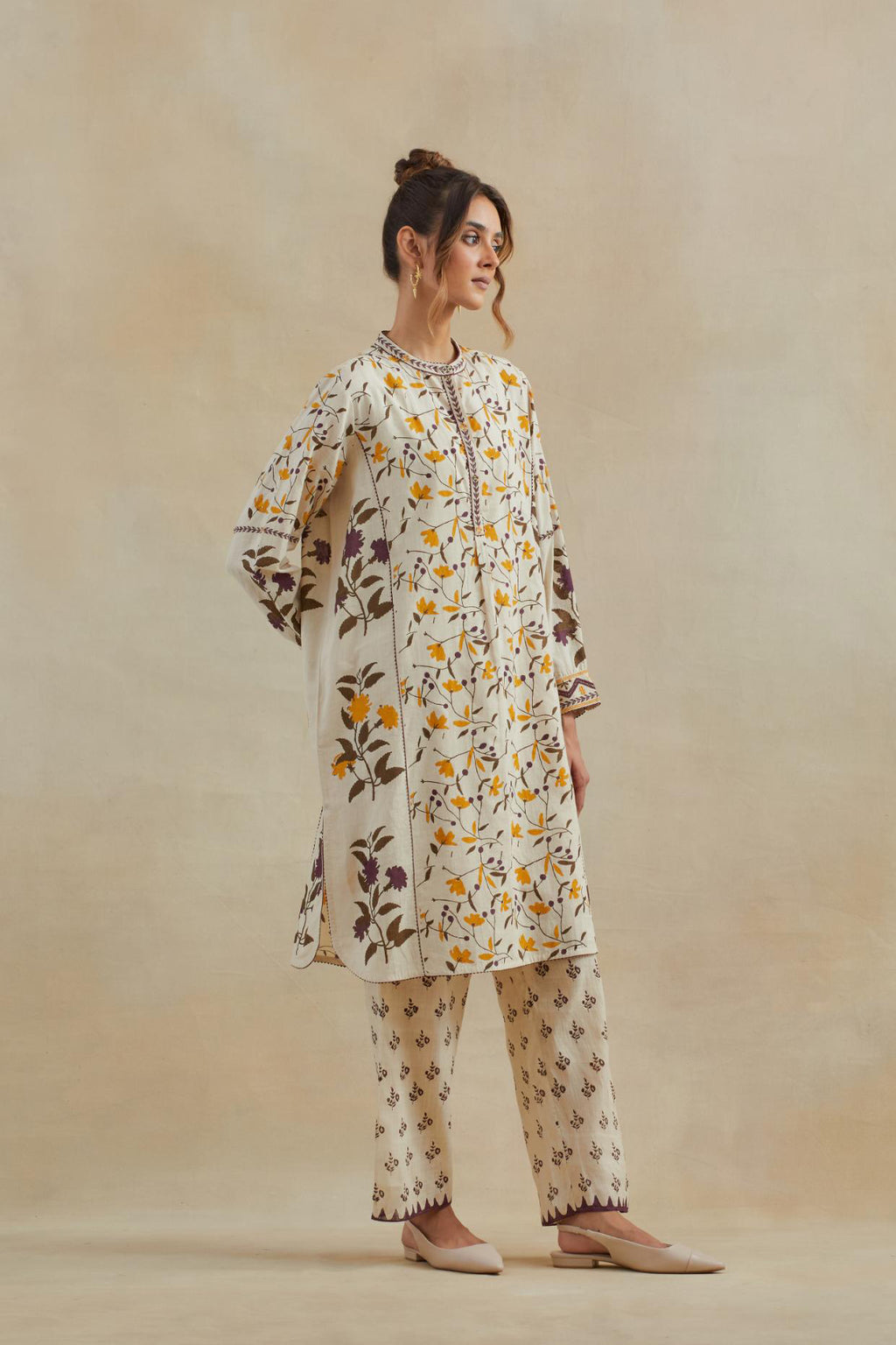 Beige short kurta crafted from soft cotton, featuring an all-over hand block print of yellow and purple flowers, paired with Beige cotton straight pants with all-over small booti hand block print.