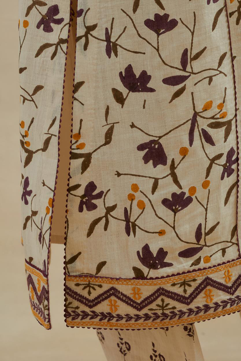 Beige cotton straight kurta set with all-over yellow & purple colored flower hand block print & and side panels.