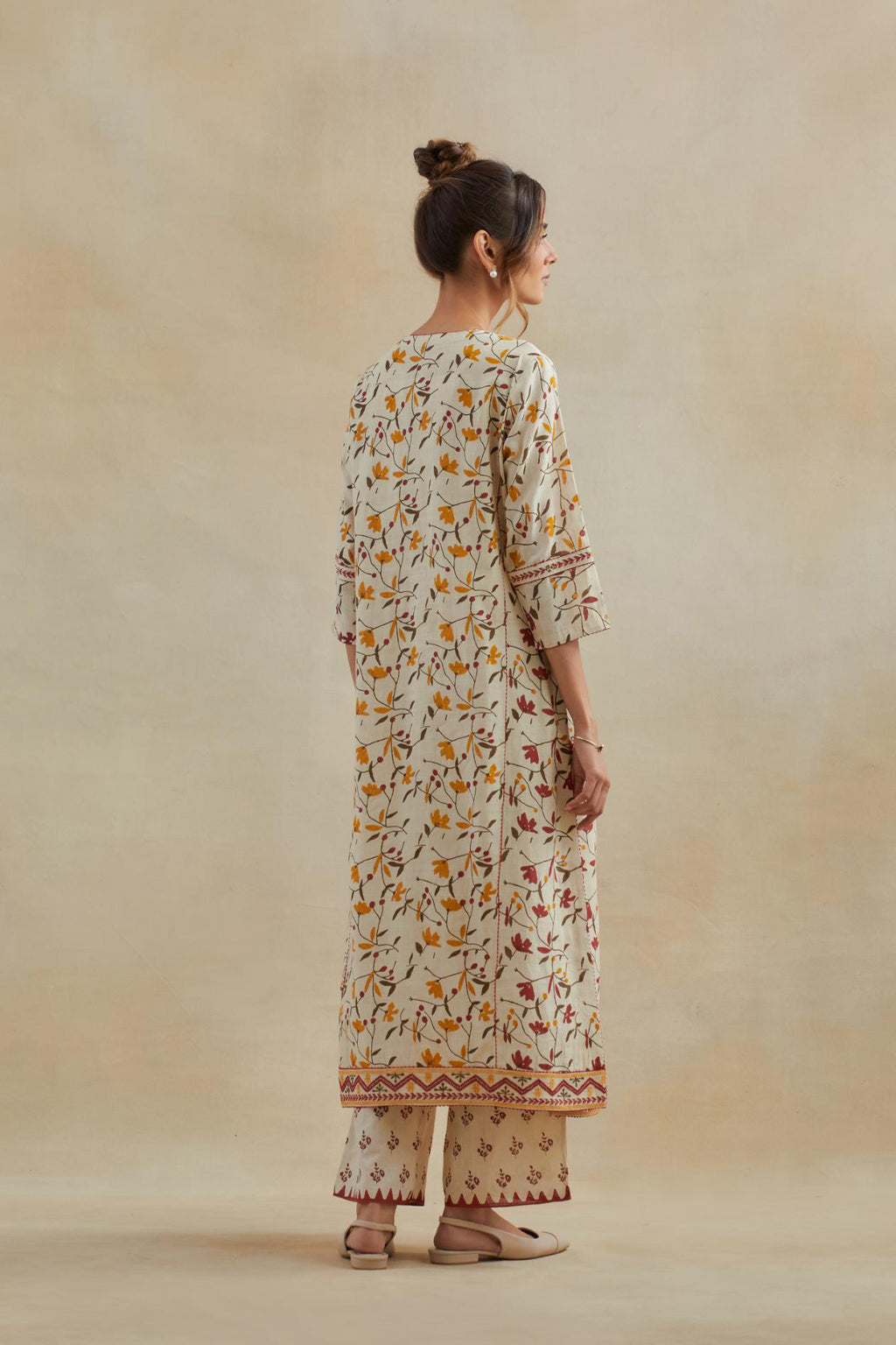 Beige cotton straight kurta set with all-over yellow & red colored flower hand block print & and side panels.