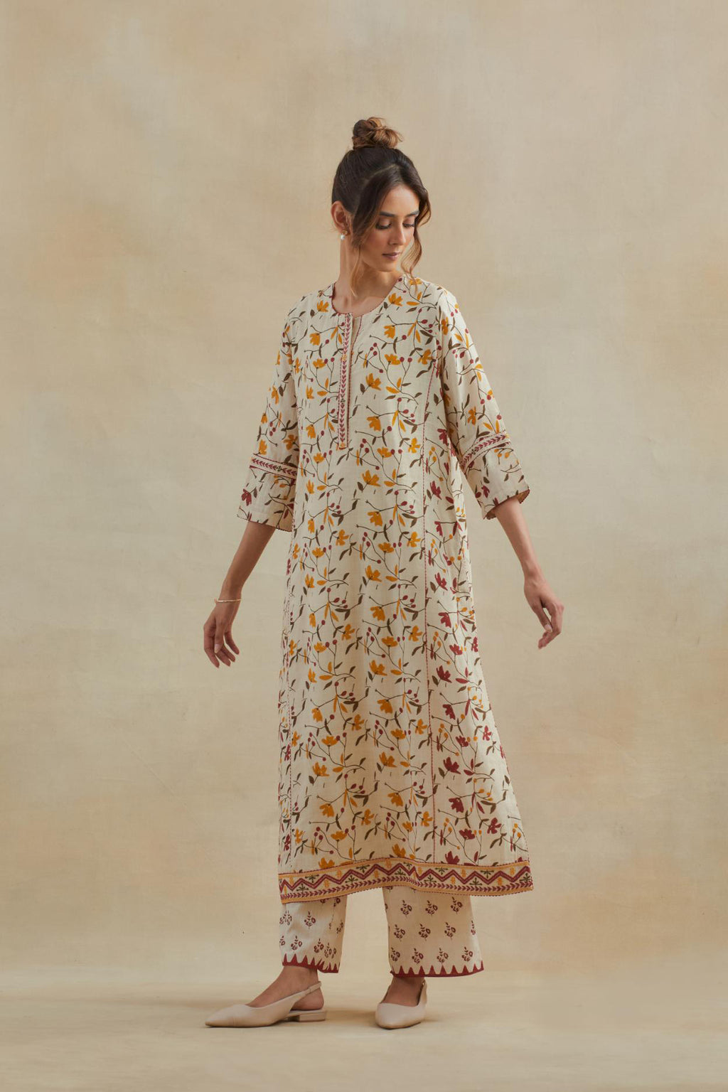Beige cotton straight kurta set with all-over yellow & red colored flower hand block print & and side panels.