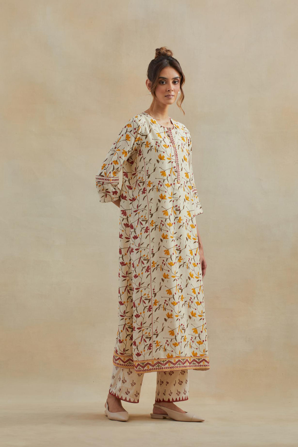 Beige cotton straight kurta set with all-over yellow & red colored flower hand block print & and side panels.