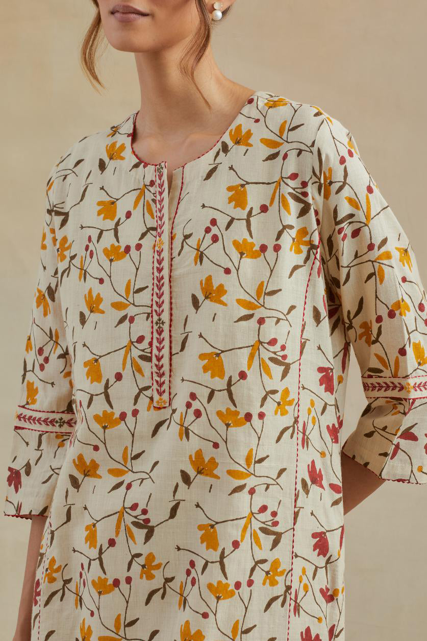 Beige cotton straight kurta set with all-over yellow & red colored flower hand block print & and side panels.
