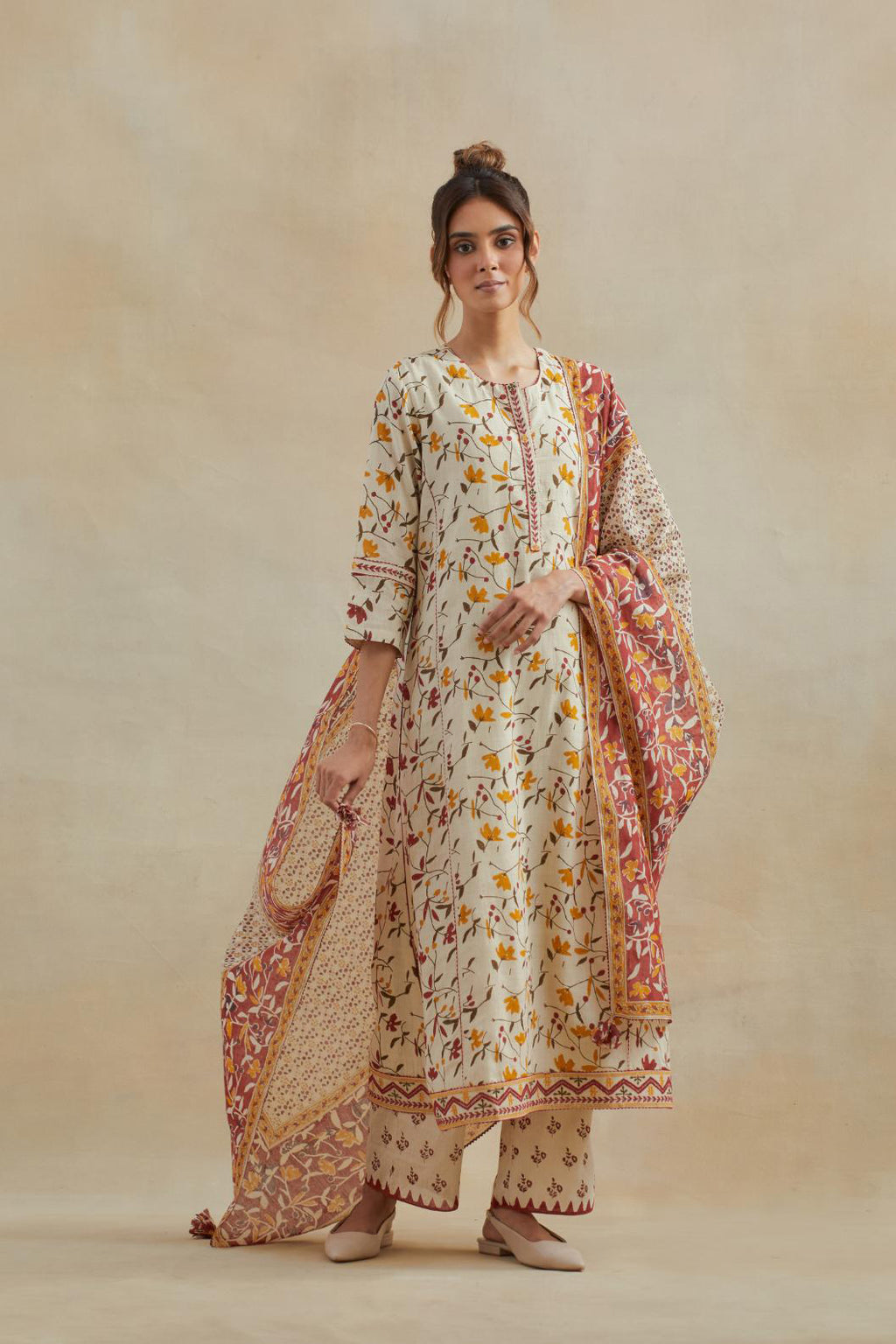 Beige cotton straight kurta set with all-over yellow & red colored flower hand block print & and side panels.