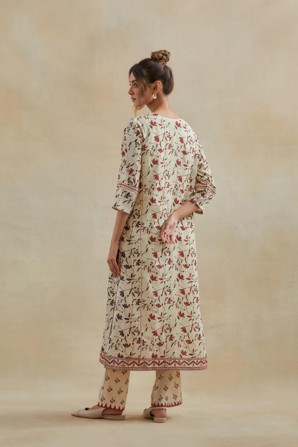 Beige cotton straight kurta set with all-over rust & green colored flower hand block print & and side panels.