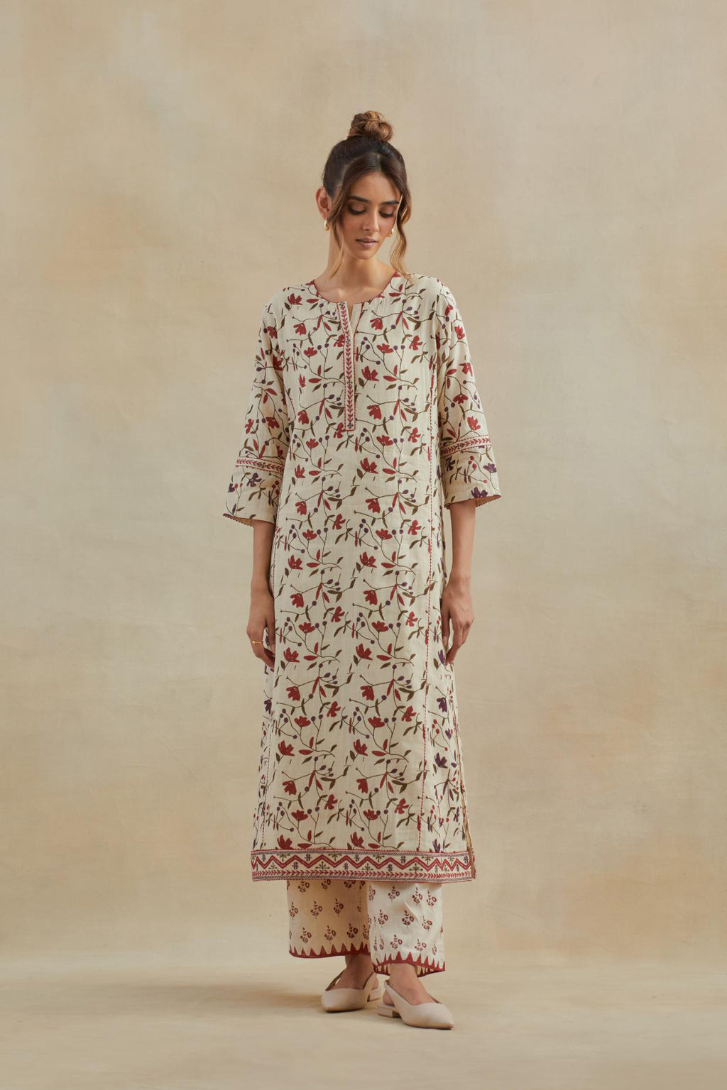 Beige cotton straight kurta set with all-over rust & green colored flower hand block print & and side panels.
