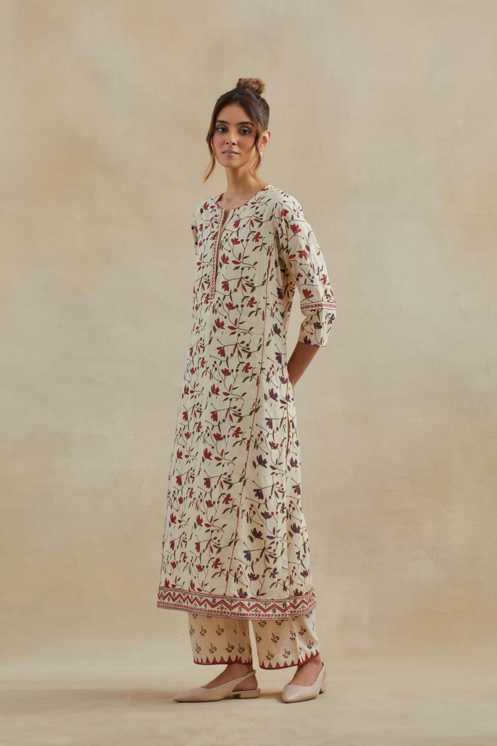 Beige cotton straight kurta set with all-over rust & green colored flower hand block print & and side panels.
