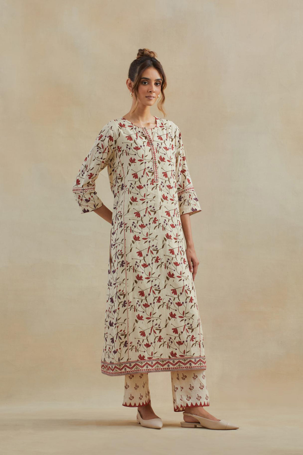 Beige cotton straight kurta set with all-over rust & green colored flower hand block print & and side panels.