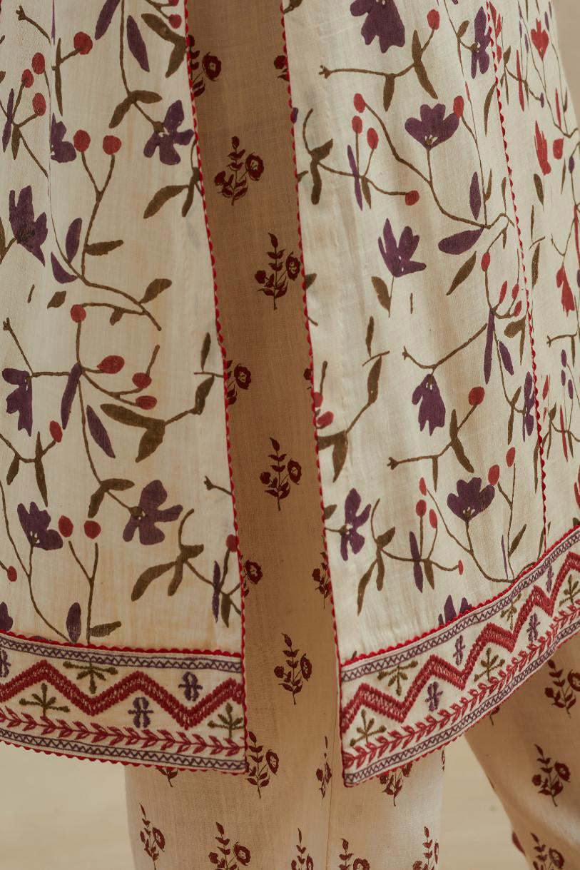Beige cotton straight kurta set with all-over rust & green colored flower hand block print & and side panels.
