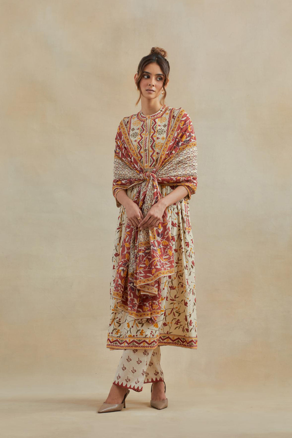 A beige cotton kurta dress set featuring an all-over yellow and red flower hand block print.