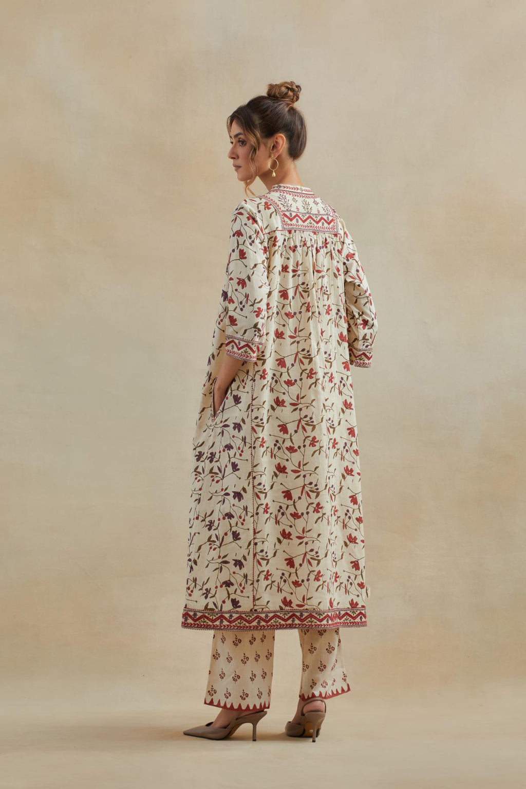 A beige cotton kurta dress set featuring an all-over rust & green flower hand block print.