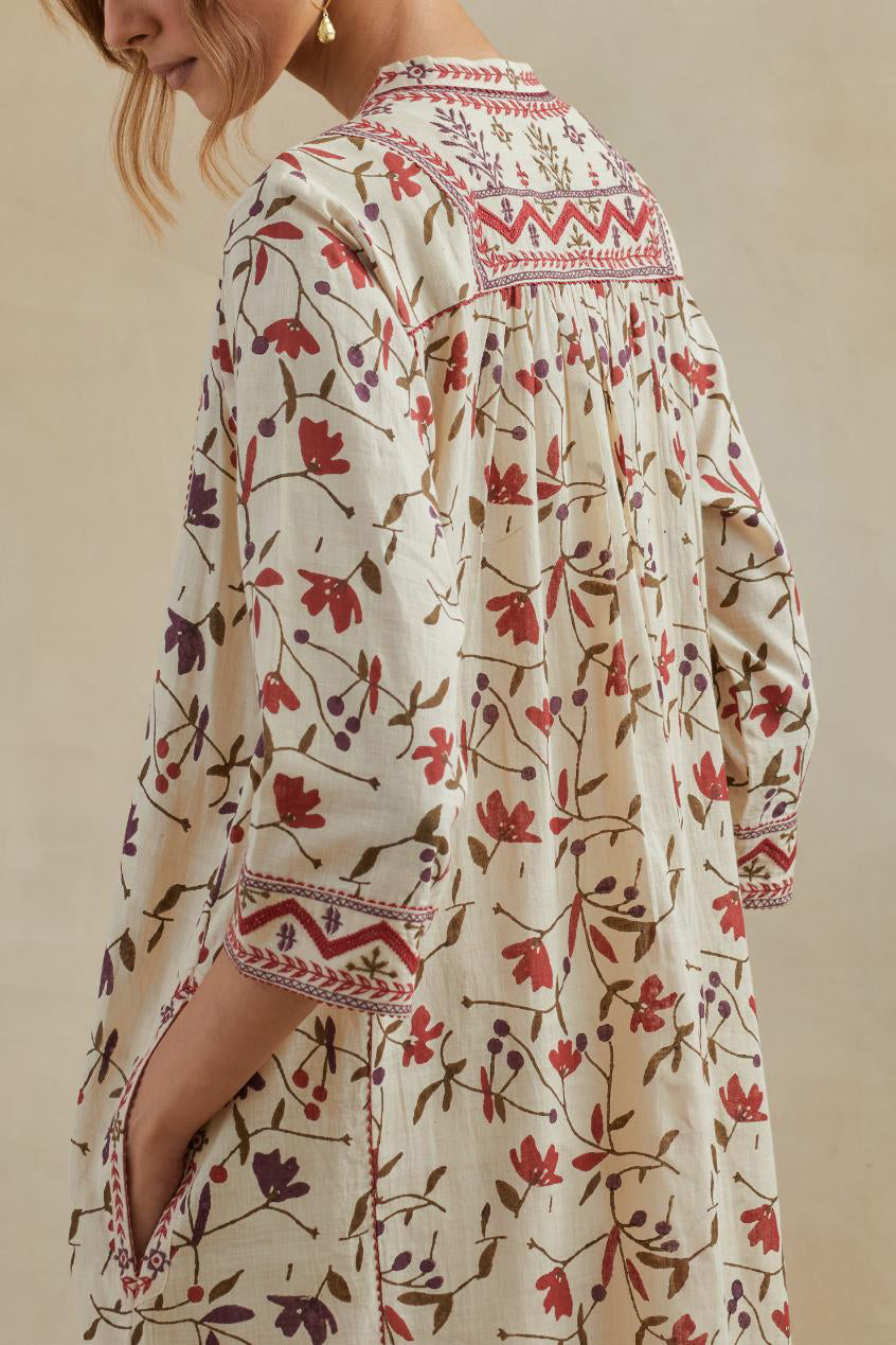 A beige cotton kurta dress set featuring an all-over rust & green flower hand block print.