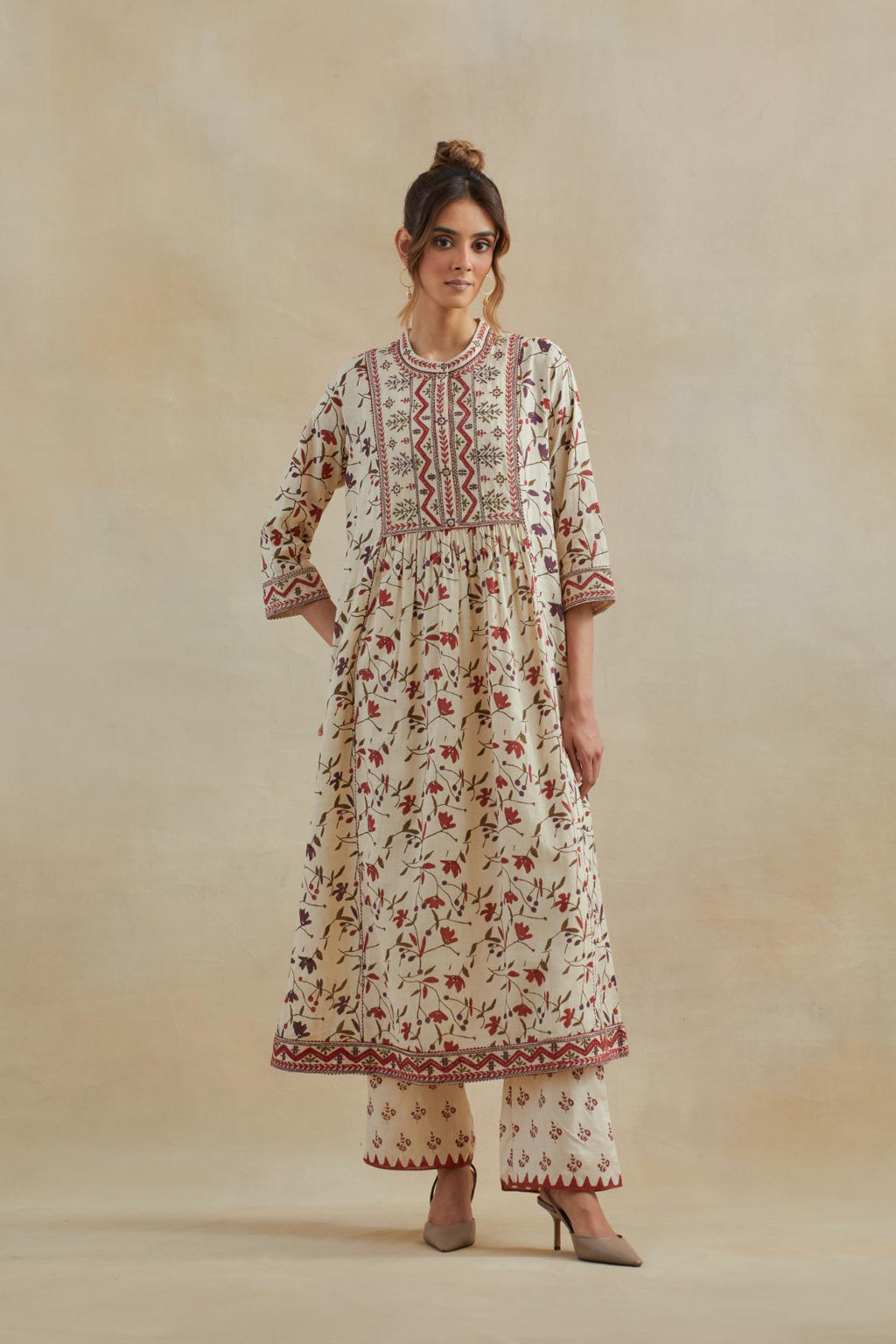 A beige cotton kurta dress set featuring an all-over rust & green flower hand block print.