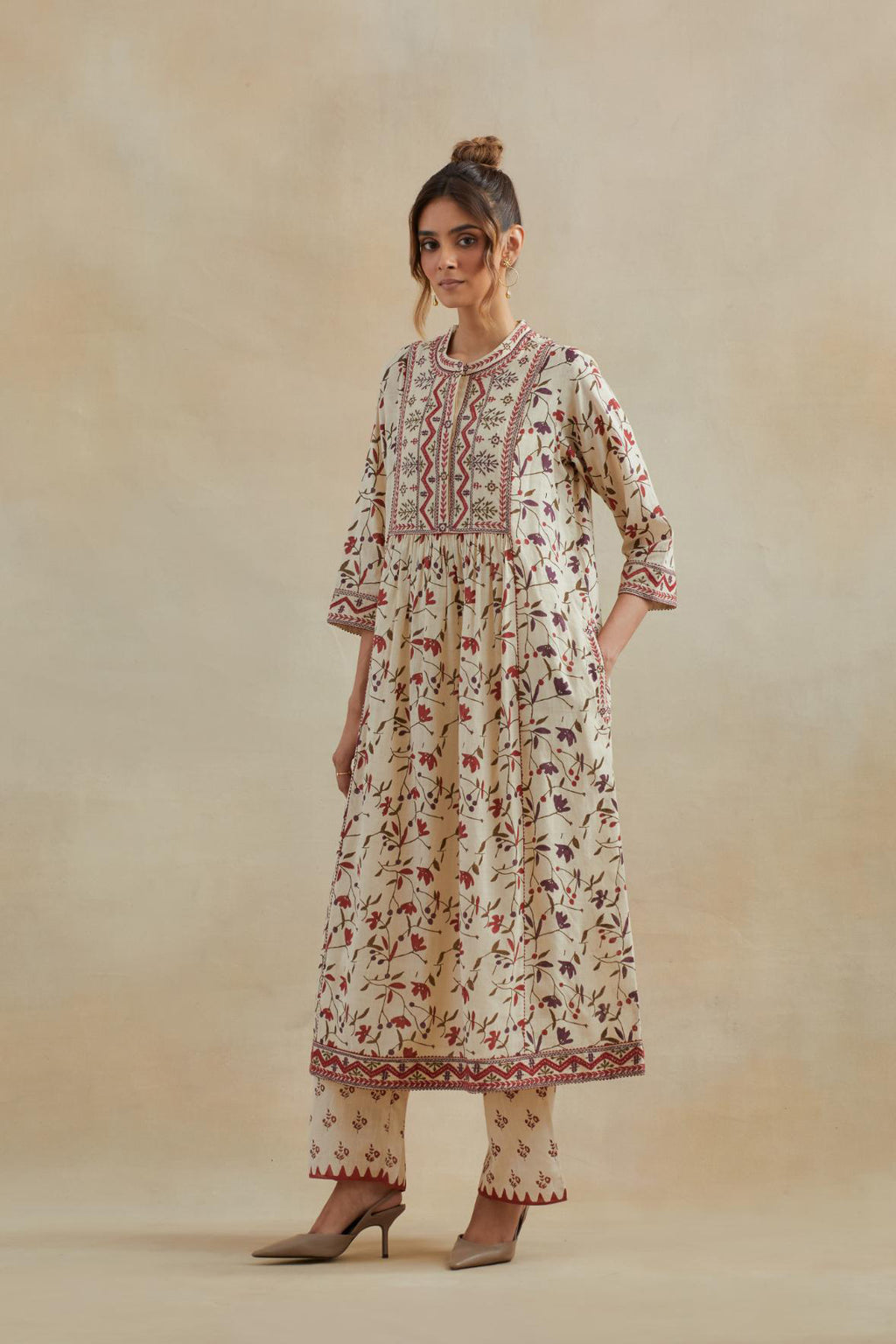 A beige cotton kurta dress set featuring an all-over rust & green flower hand block print.