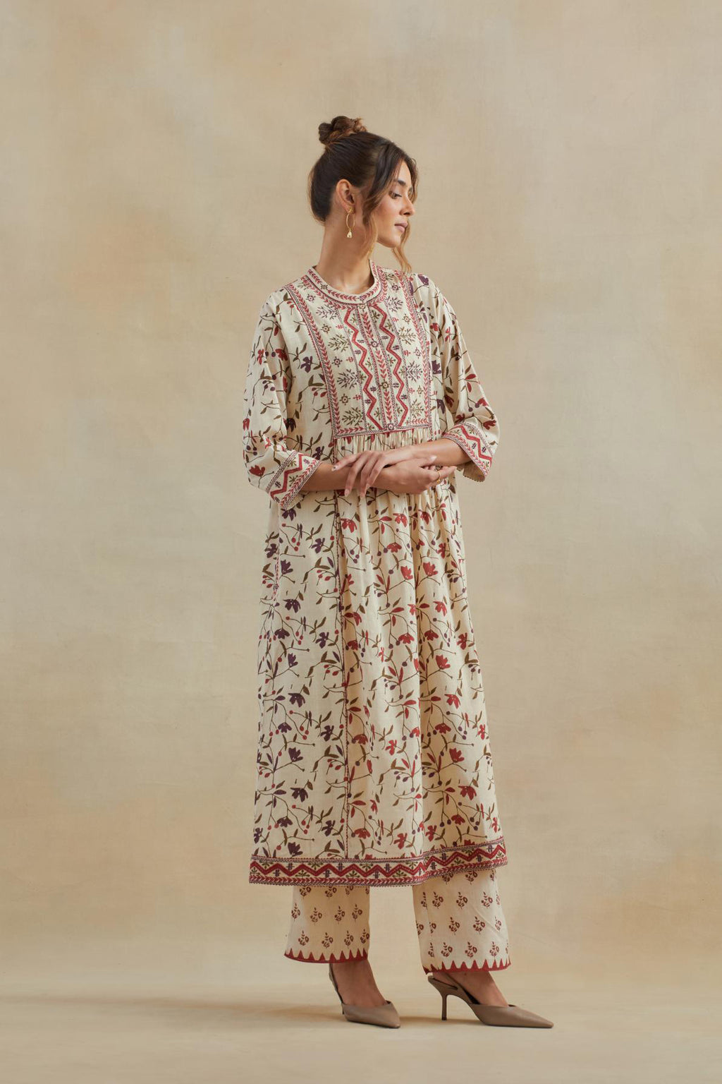 A beige cotton kurta dress set featuring an all-over rust & green flower hand block print.