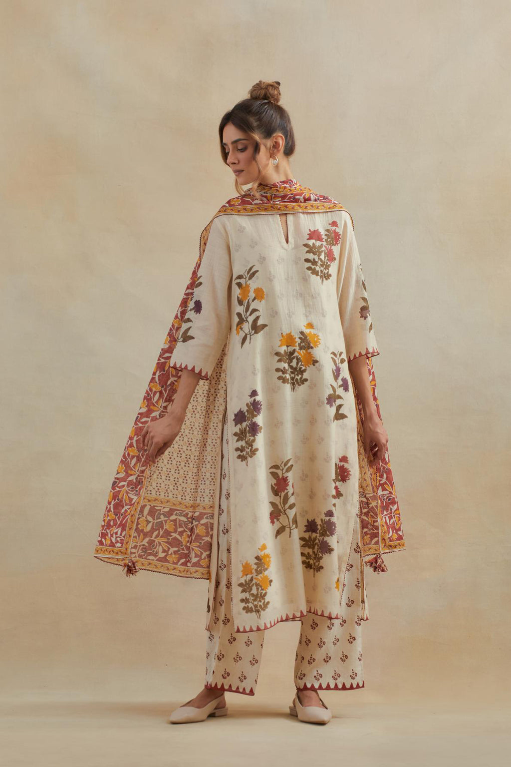 Beige cotton chanderi straight kurta set with all-over multi colored floral hand block print.