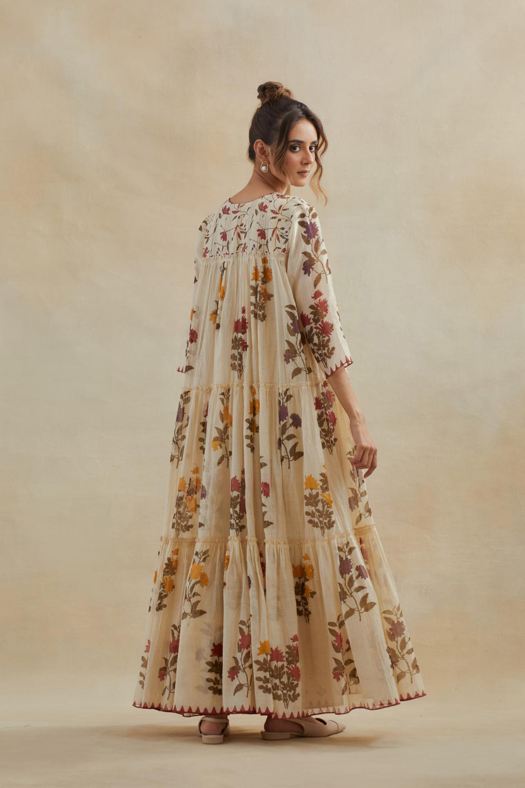 Beige cotton chanderi three-tiered kurta set with quilted yoke and all-over multi colored floral hand block print.