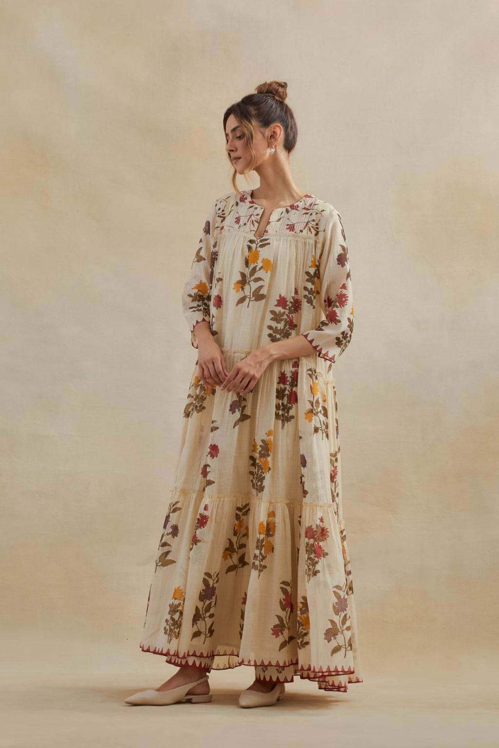 Beige cotton chanderi three-tiered kurta set with quilted yoke and all-over multi colored floral hand block print.