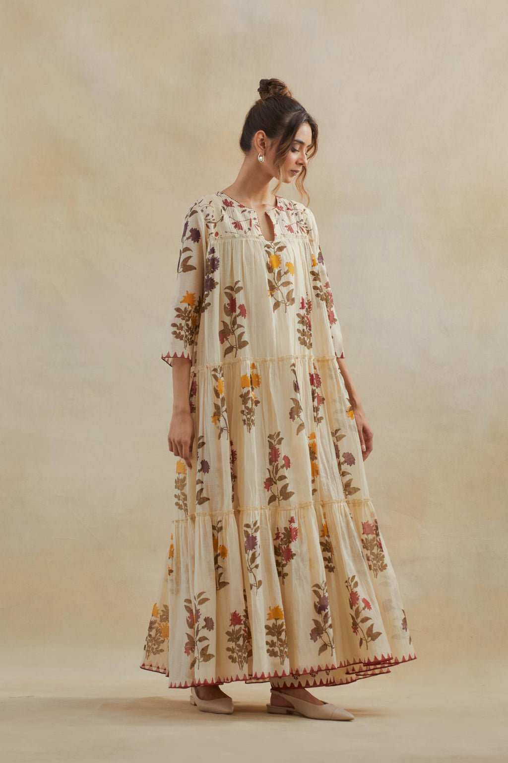 Beige cotton chanderi three-tiered kurta set with quilted yoke and all-over multi colored floral hand block print.