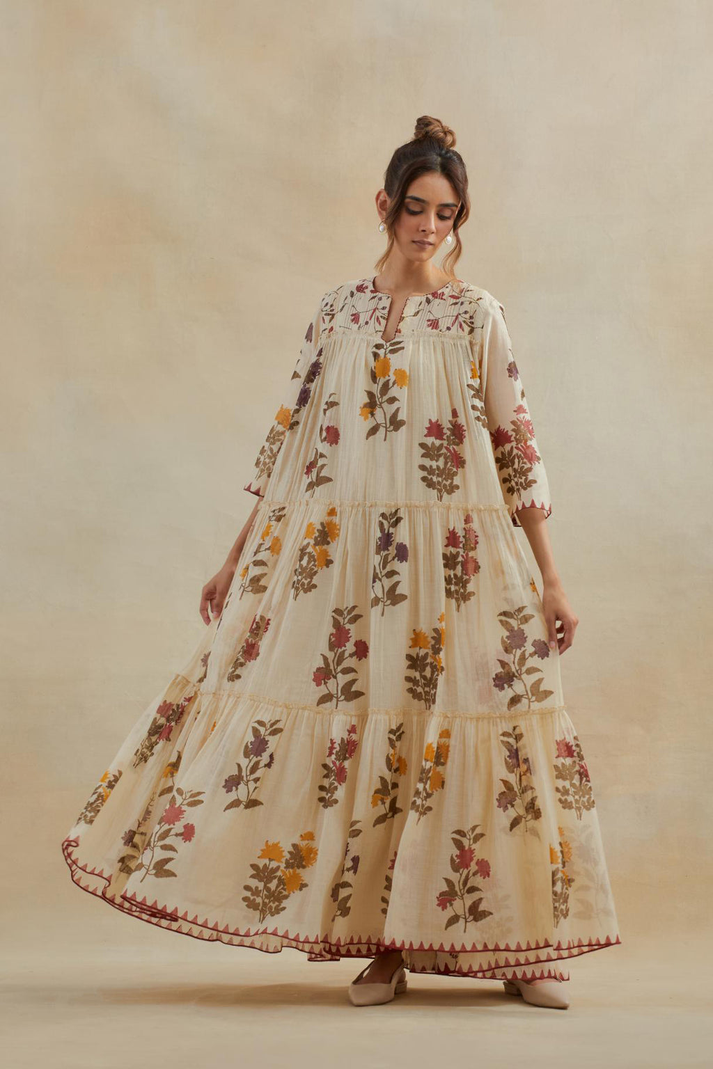 Beige cotton chanderi three-tiered kurta set with quilted yoke and all-over multi colored floral hand block print.