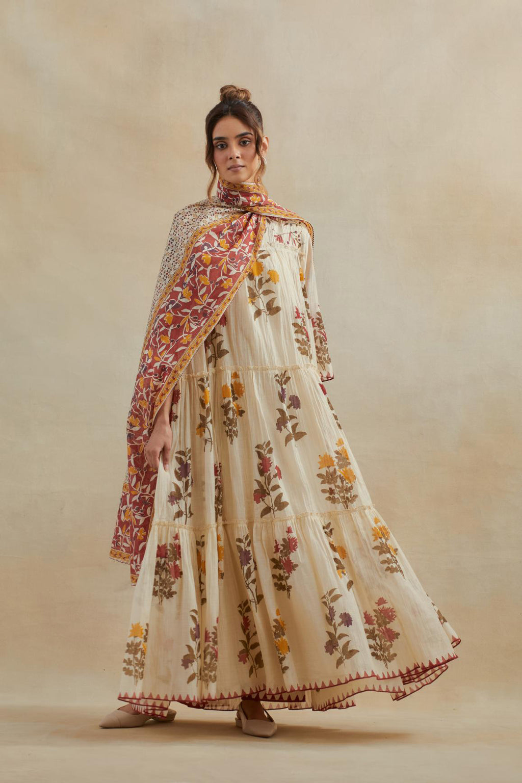 Beige cotton chanderi three-tiered kurta set with quilted yoke and all-over multi colored floral hand block print.