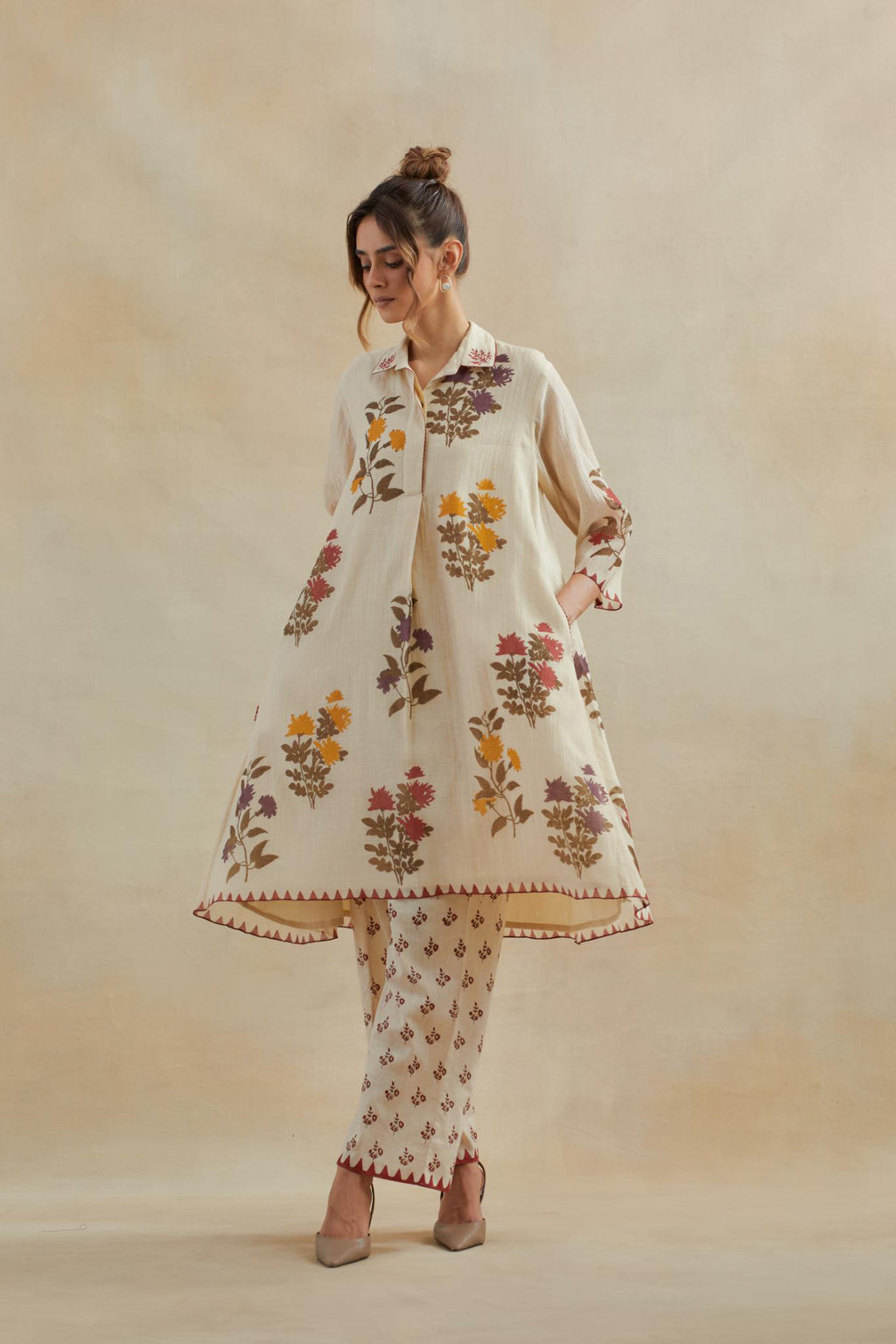 Beige cotton chanderi hand block printed A-line short kurta set with all-over multi colored flower.