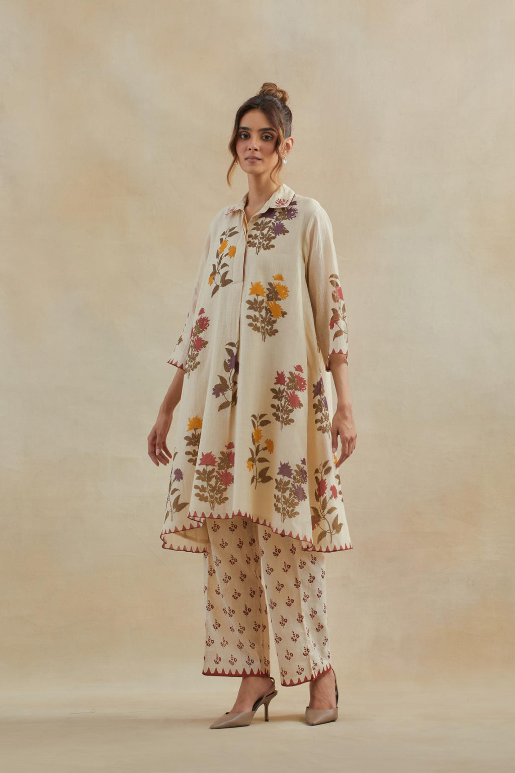 Beige cotton chanderi hand block printed A-line short kurta set with all-over multi colored flower.