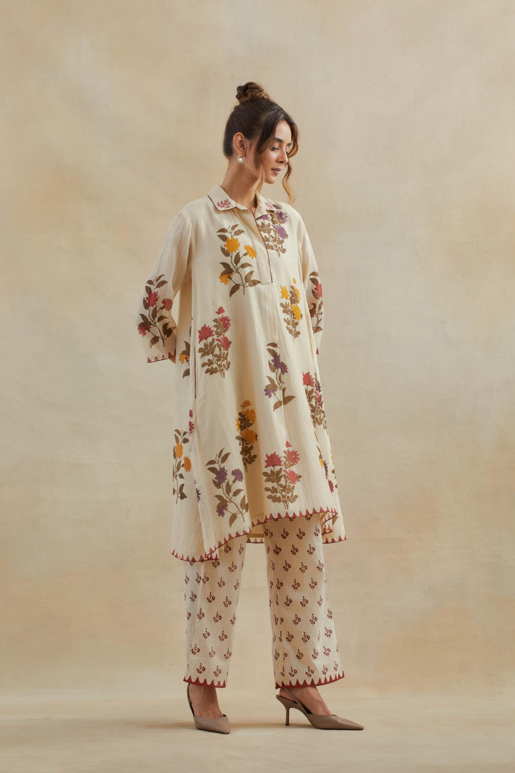 Beige cotton chanderi hand block printed A-line short kurta set with all-over multi colored flower.