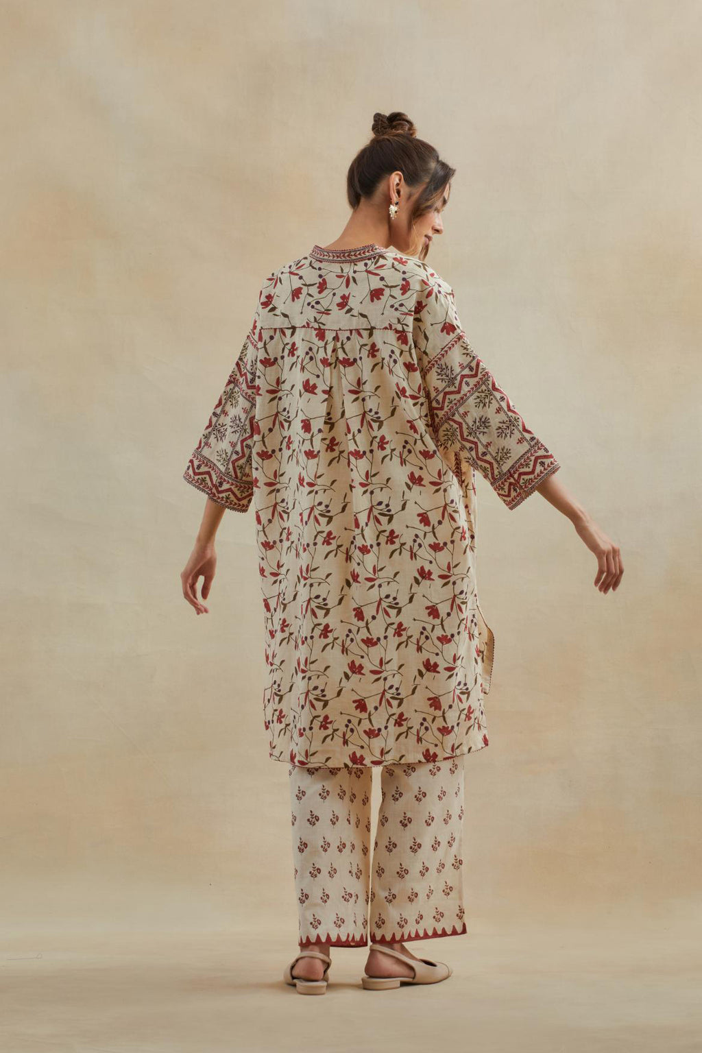 Beige cotton easy fit short kurta with all-over rust & green hand block print, highlighted with silk thread embroidery, paired with beige cotton straight pants with all-over small booti hand block print.