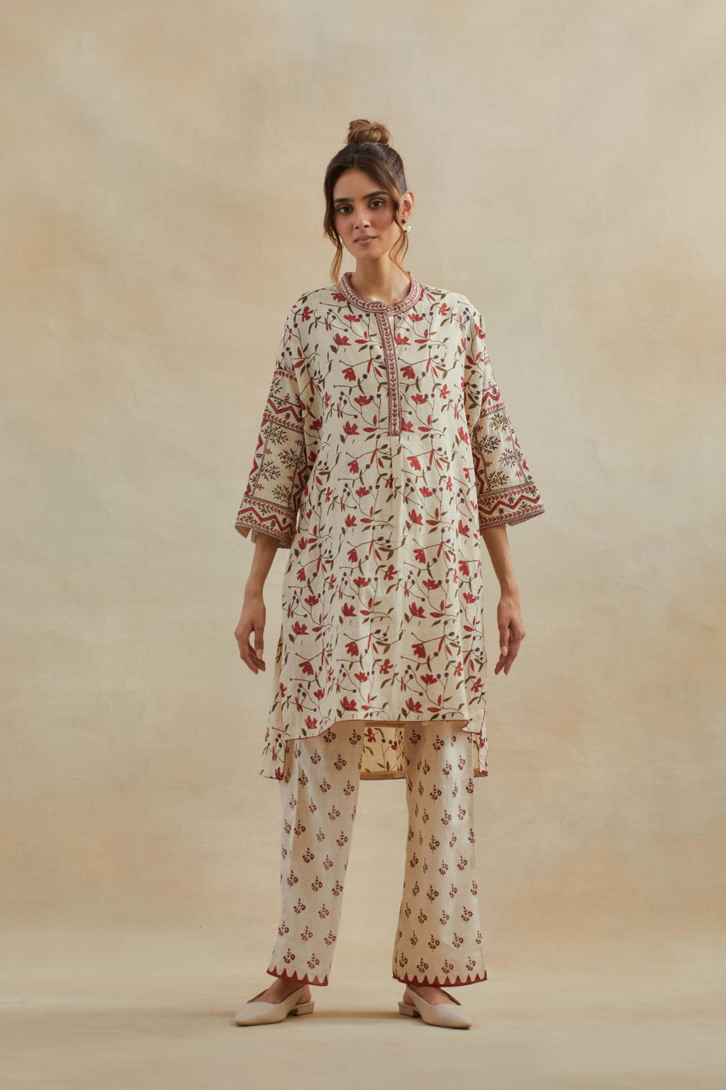 Beige cotton easy fit short kurta with all-over rust & green hand block print, highlighted with silk thread embroidery, paired with beige cotton straight pants with all-over small booti hand block print.