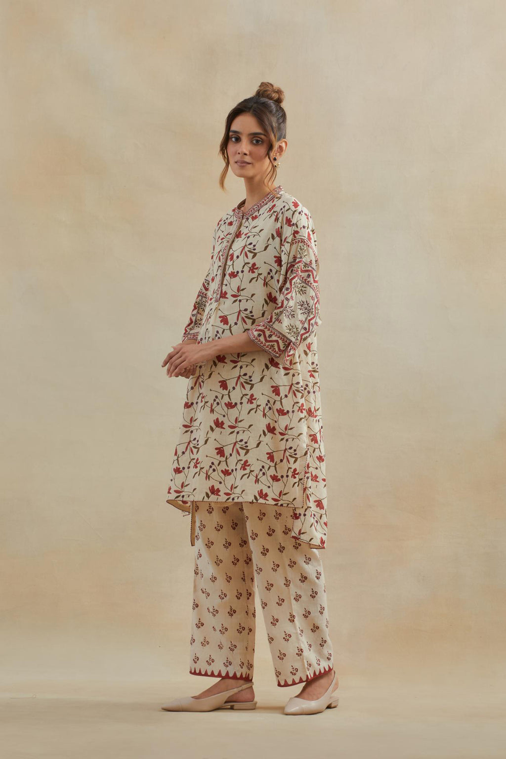 Beige cotton easy fit short kurta with all-over rust & green hand block print, highlighted with silk thread embroidery, paired with beige cotton straight pants with all-over small booti hand block print.