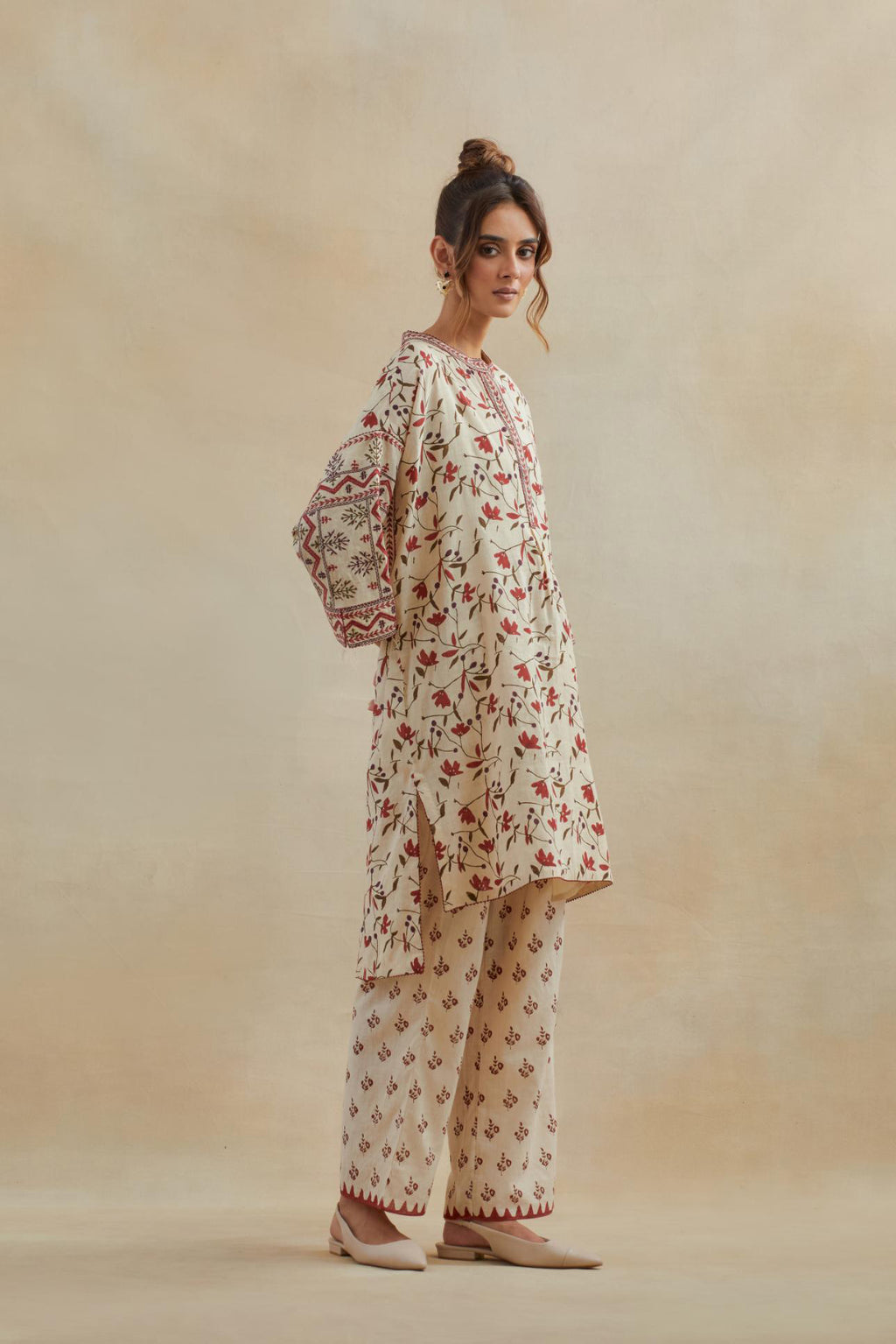 Beige cotton easy fit short kurta with all-over rust & green hand block print, highlighted with silk thread embroidery, paired with beige cotton straight pants with all-over small booti hand block print.