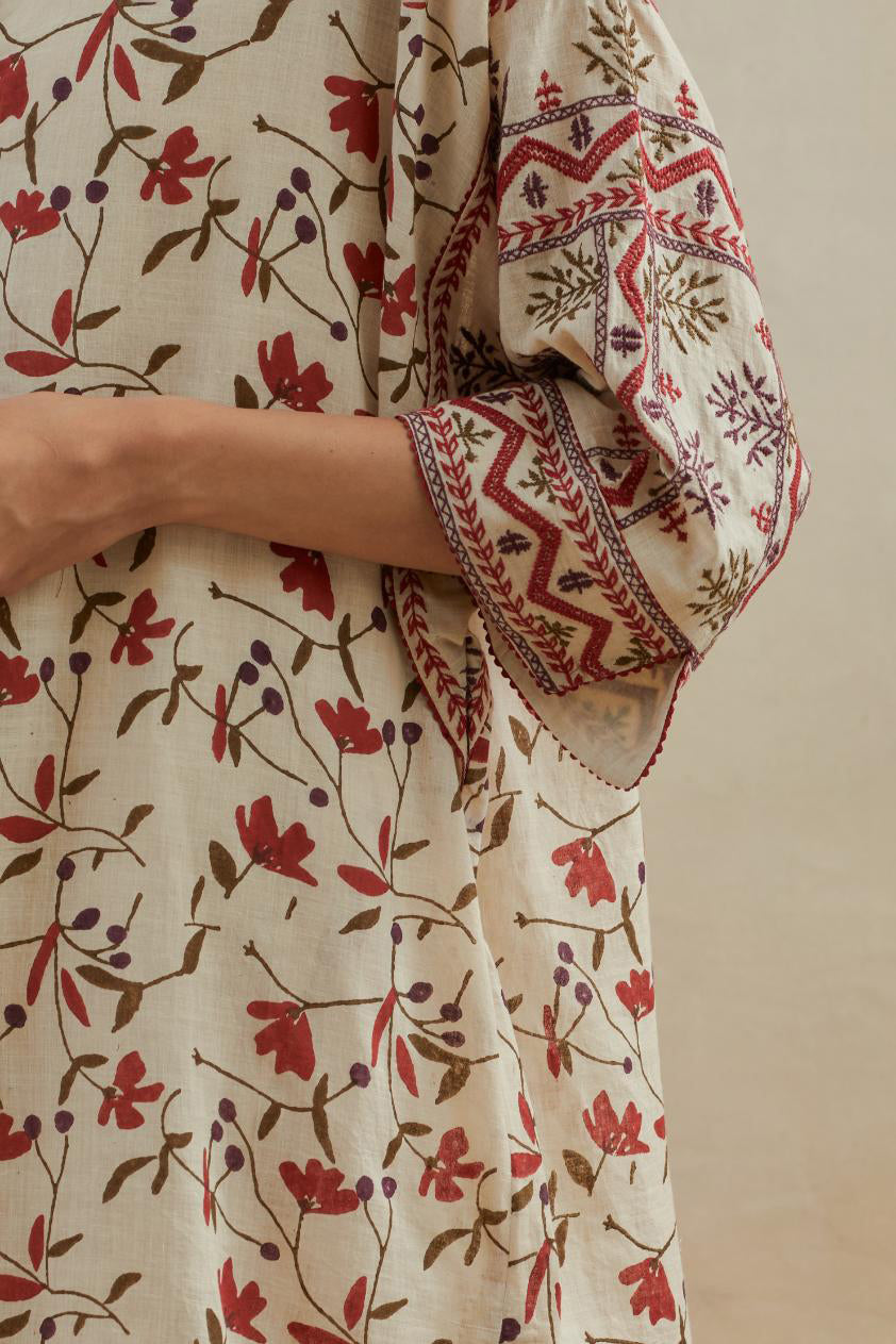 Beige cotton easy fit short kurta with all-over rust & green hand block print, highlighted with silk thread embroidery, paired with beige cotton straight pants with all-over small booti hand block print.