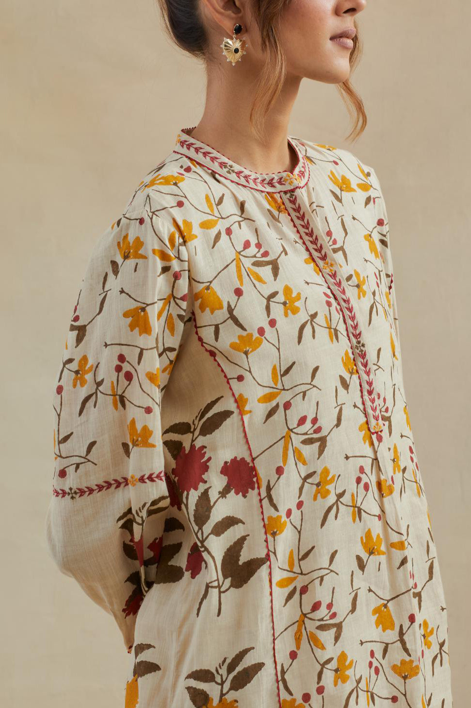 Beige short kurta crafted from soft cotton, featuring an all-over hand block print of yellow and red flowers, paired with Beige cotton straight pants with all-over small booti hand block print.