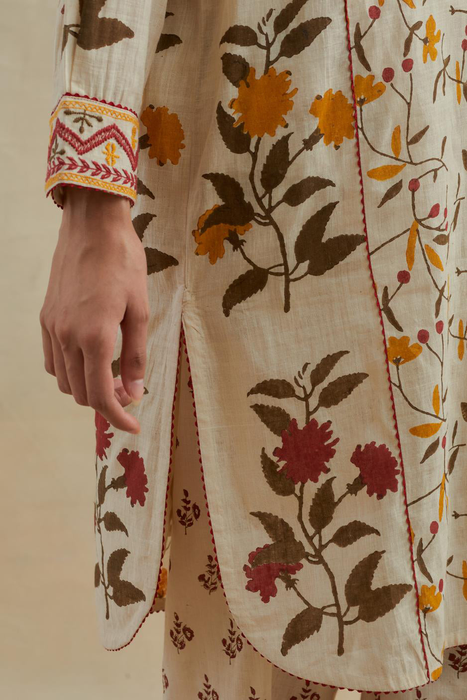 Beige short kurta crafted from soft cotton, featuring an all-over hand block print of yellow and red flowers, paired with Beige cotton straight pants with all-over small booti hand block print.