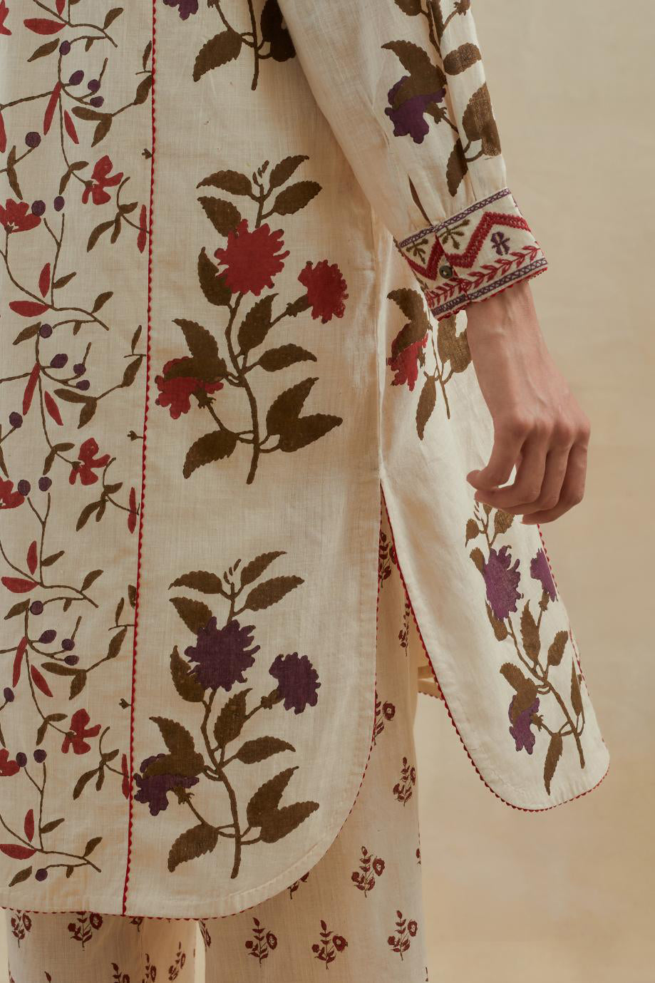 Beige short kurta crafted from soft cotton, featuring an all-over hand block print of red & green flowers, paired with Beige cotton straight pants with all-over small booti hand block print.
