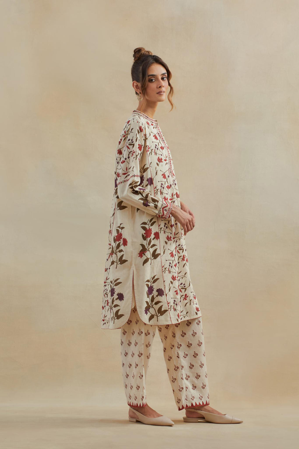 Beige short kurta crafted from soft cotton, featuring an all-over hand block print of red & green flowers, paired with Beige cotton straight pants with all-over small booti hand block print.