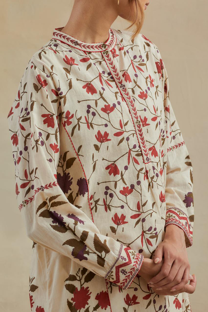 Beige short kurta crafted from soft cotton, featuring an all-over hand block print of red & green flowers, paired with Beige cotton straight pants with all-over small booti hand block print.