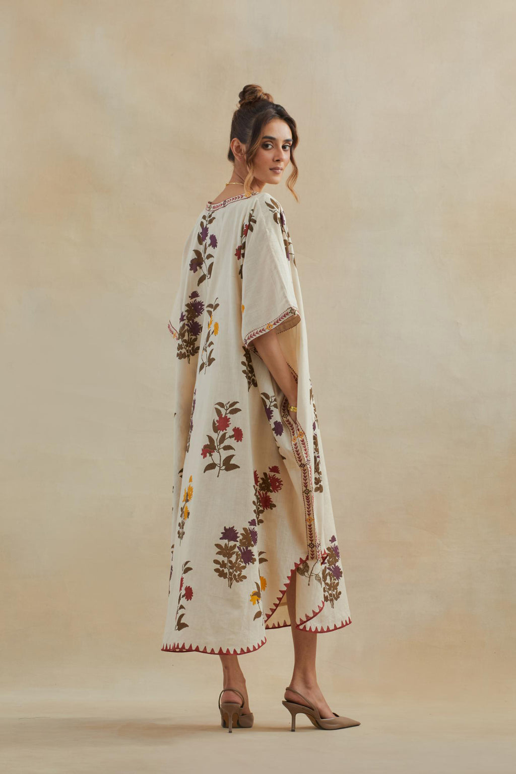 Beige cotton easy fit kaftan with all-over multi colored flower hand block print, highlighted with thread embroidery at sides, paired with beige cotton straight pants with all-over small booti hand block print.