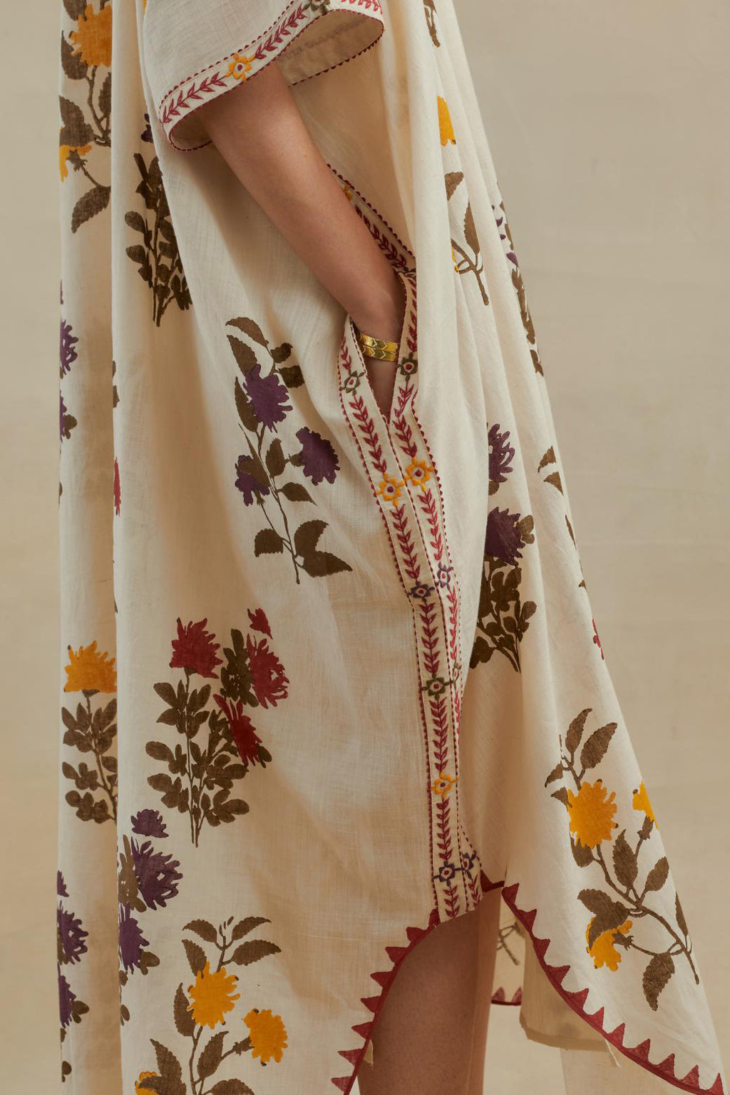 Beige cotton easy fit kaftan with all-over multi colored flower hand block print, highlighted with thread embroidery at sides, paired with beige cotton straight pants with all-over small booti hand block print.