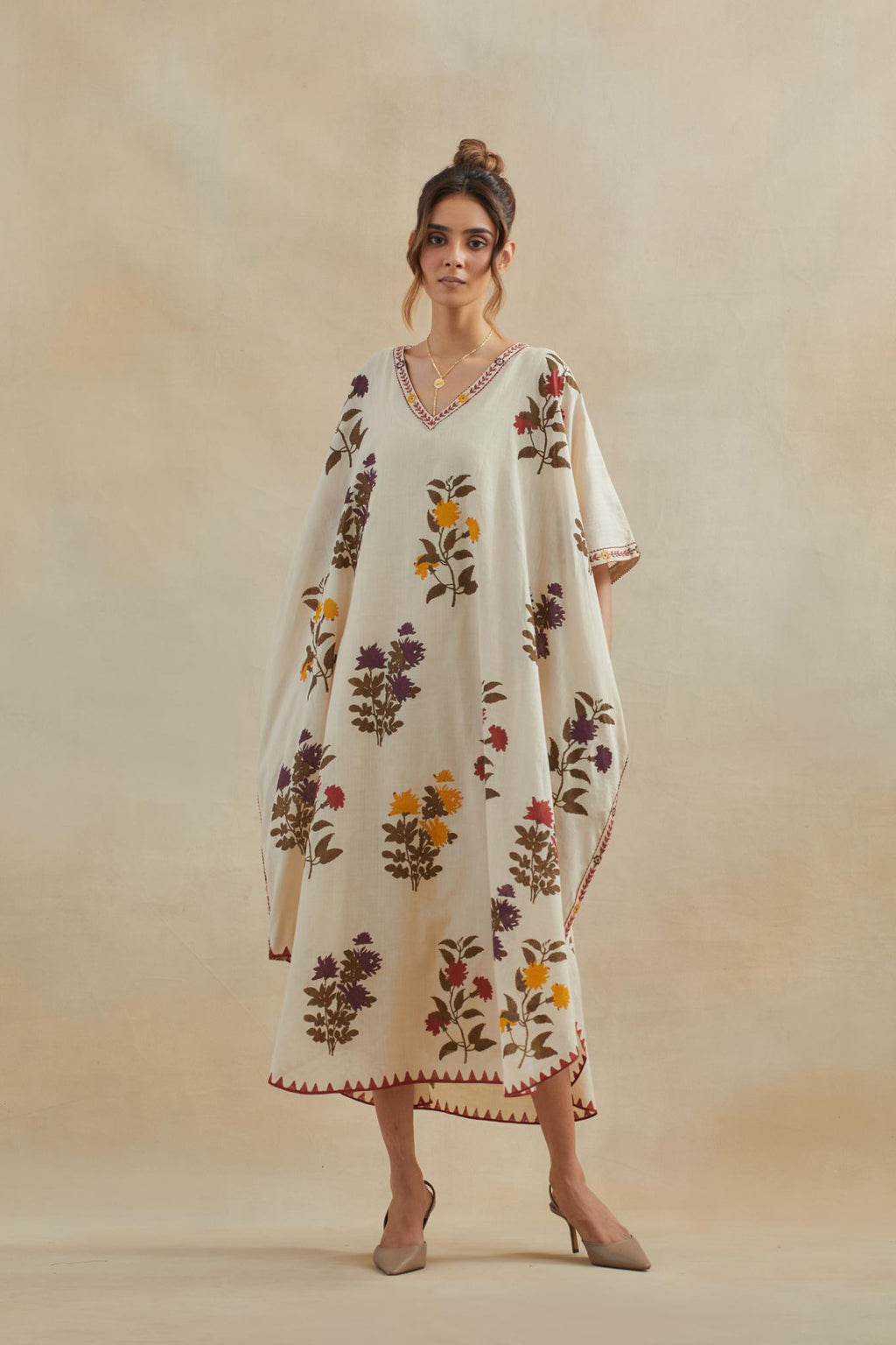 Beige cotton easy fit kaftan with all-over multi colored flower hand block print, highlighted with thread embroidery at sides, paired with beige cotton straight pants with all-over small booti hand block print.