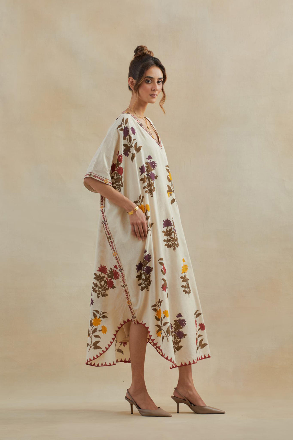 Beige cotton easy fit kaftan with all-over multi colored flower hand block print, highlighted with thread embroidery at sides, paired with beige cotton straight pants with all-over small booti hand block print.