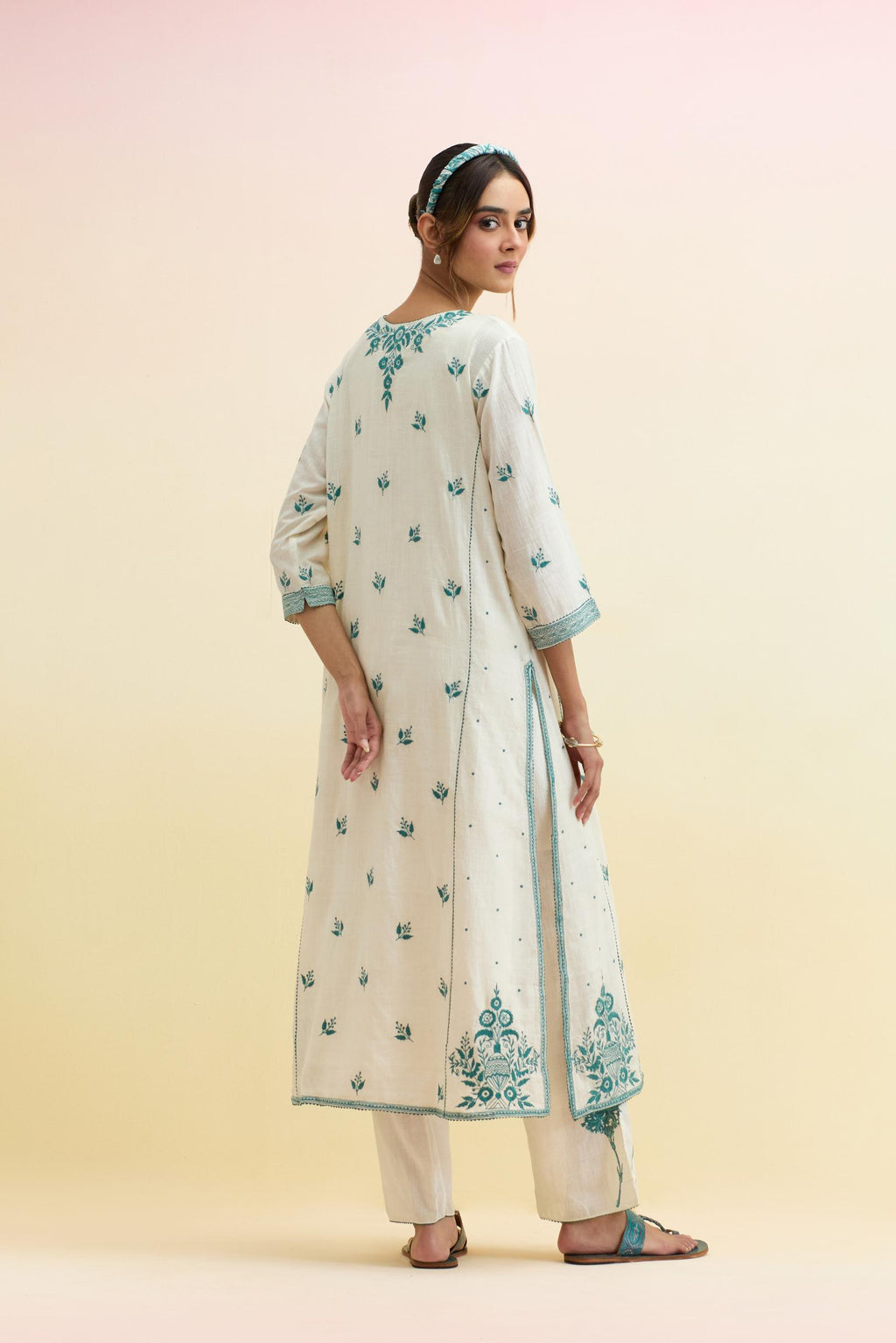 Off white cotton kalidar straight kurta set, highlighted with tropical teal thread embroidery.