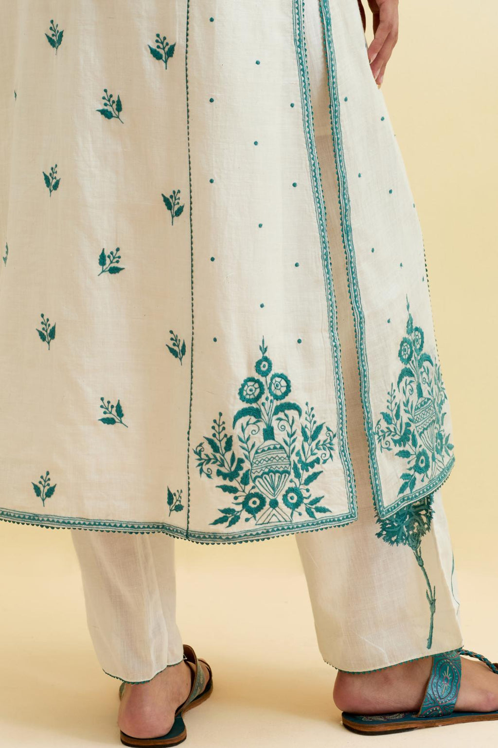 Off white cotton kalidar straight kurta set, highlighted with tropical teal thread embroidery.