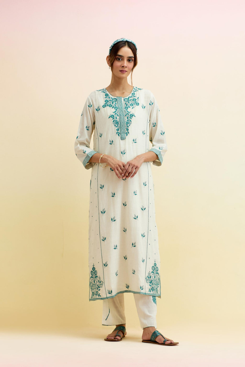 Off white cotton kalidar straight kurta set, highlighted with tropical teal thread embroidery.