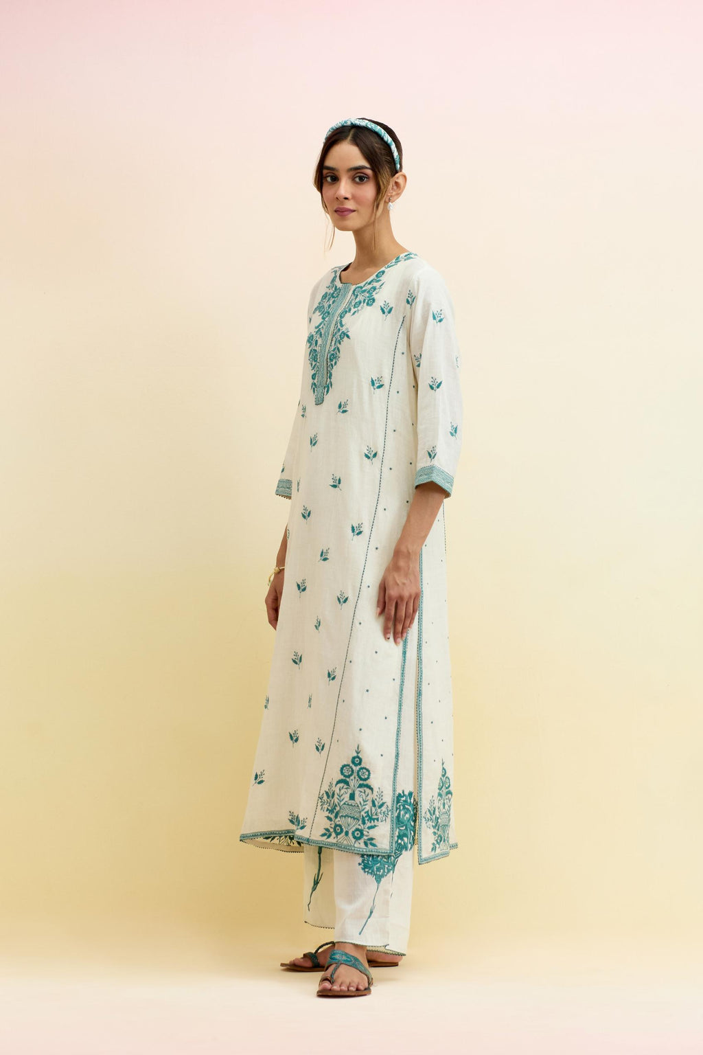 Off white cotton kalidar straight kurta set, highlighted with tropical teal thread embroidery.