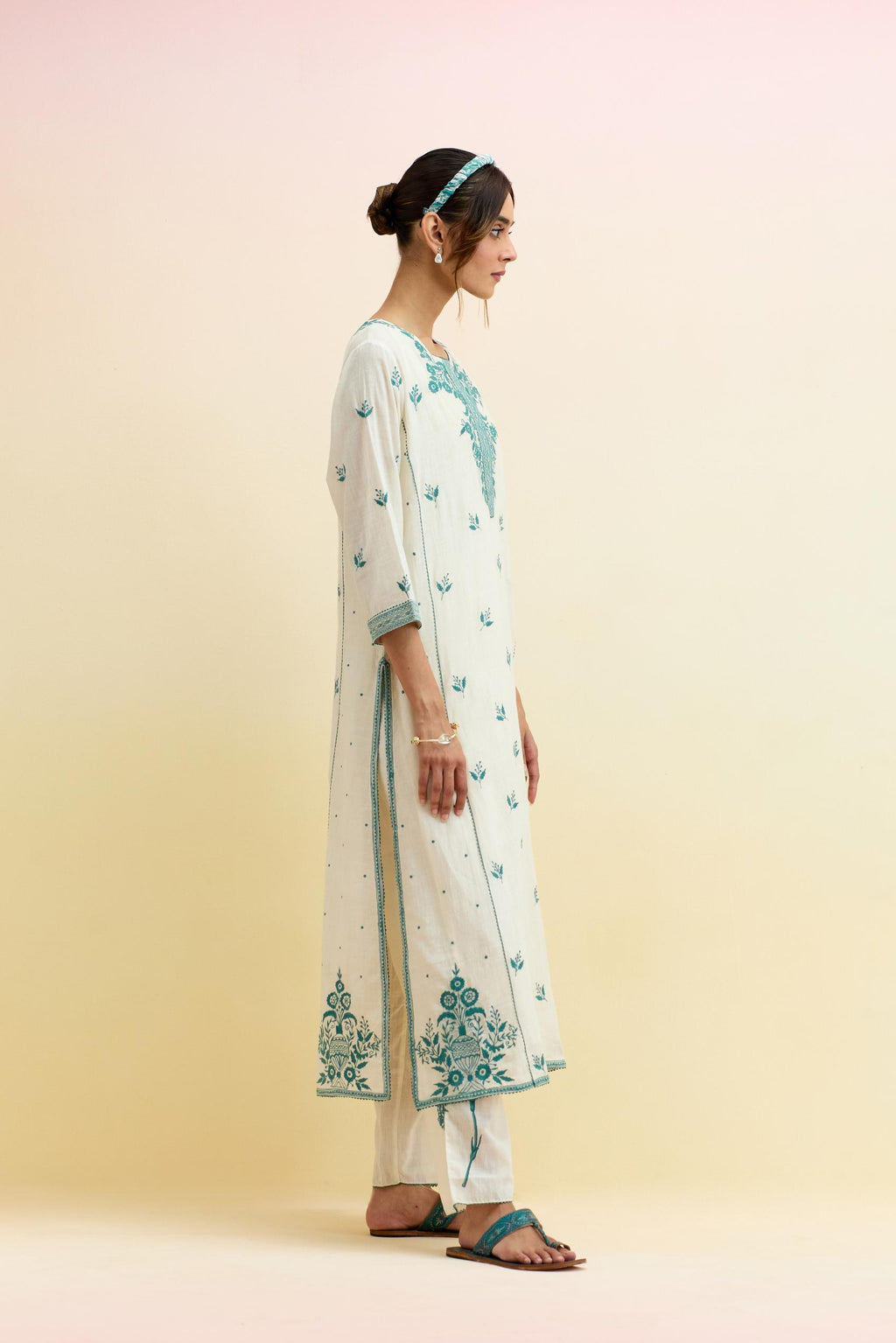 Off white cotton kalidar straight kurta set, highlighted with tropical teal thread embroidery.