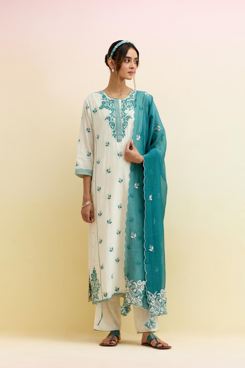 Off white cotton kalidar straight kurta set, highlighted with tropical teal thread embroidery.