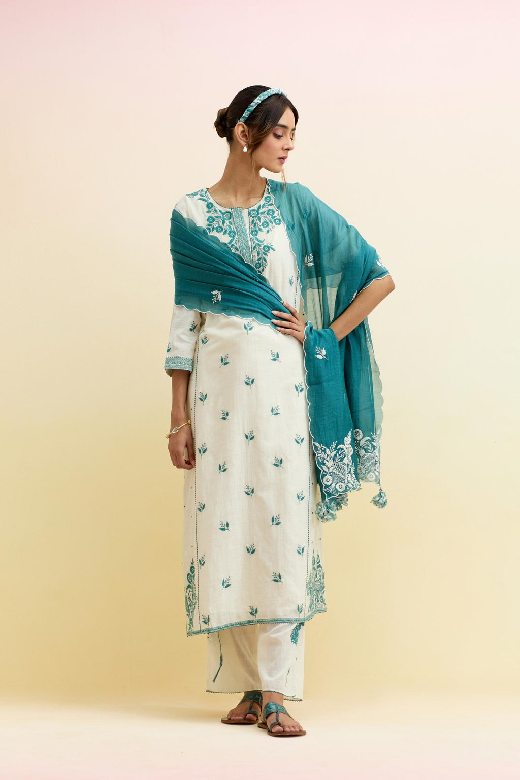 Off white cotton kalidar straight kurta set, highlighted with tropical teal thread embroidery.