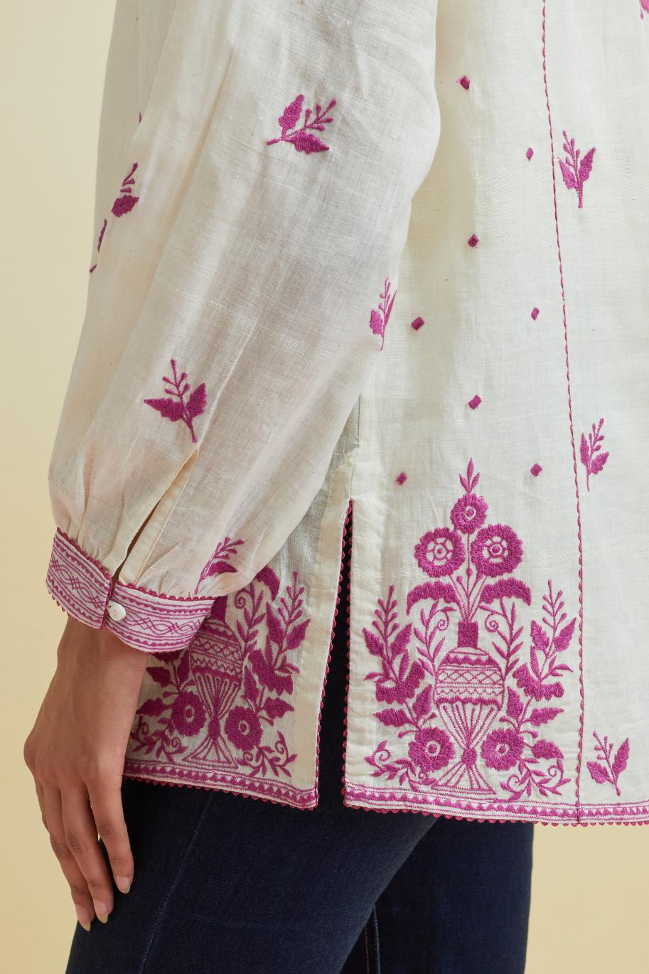 Off white cotton straight short top with all-over orchid pink thread embroidery.